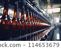 Brown glass beer bottles on conveyor belt in modern brewery production line, alcohol drink industry 114653679