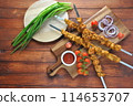 Barbecue meat. Chicken kebab. Chicken Shashlik with vegetables on wooden background. Rustic style. Top view 114653707