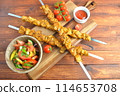 Barbecue meat. Chicken kebab. Chicken Shashlik with vegetables on wooden background. Rustic style. Top view 114653708