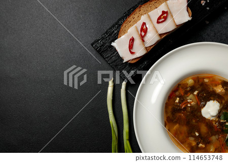 Green Borscht with nettles and sorrel. Garlic, lard sandwich Green Borscht with nettles and sorrel. Garlic, lard sandwich 114653748