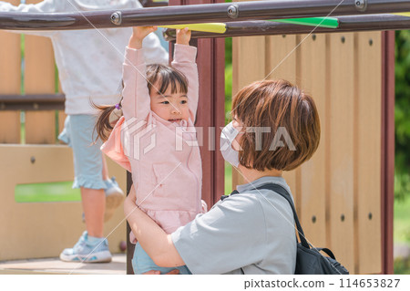Children and moms (girls, toddlers, kindergarteners) playing and exercising on park playground equipment and ladders 114653827