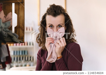 Stylish woman with curly hair in craft textile store, design concept Stylish woman with curly hair in craft textile store, design concept 114654604