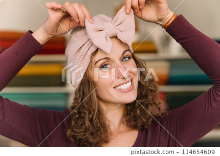 Stylish woman with curly hair in craft textile store, design concept 114654609