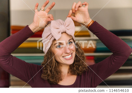 Stylish woman with curly hair in craft textile store, design concept Stylish woman with curly hair in craft textile store, design concept 114654610