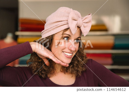 Stylish woman with curly hair in craft textile store, design concept Stylish woman with curly hair in craft textile store, design concept 114654612