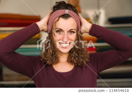 Stylish woman with curly hair in craft textile store, design concept Stylish woman with curly hair in craft textile store, design concept 114654618