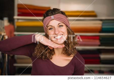 Stylish woman with curly hair in craft textile store, design concept Stylish woman with curly hair in craft textile store, design concept 114654627