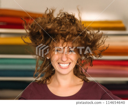 Stylish woman with curly hair in craft textile store, design concept Stylish woman with curly hair in craft textile store, design concept 114654640