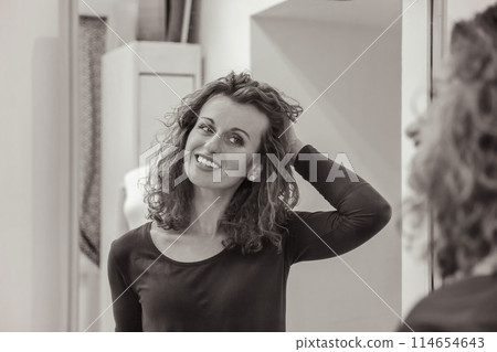 Stylish woman with curly hair in craft textile store, design concept 114654643