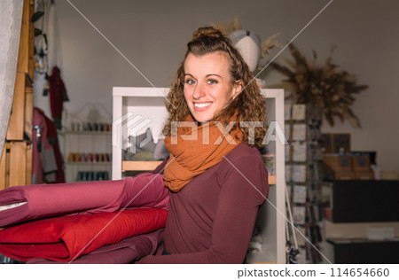 Stylish woman with curly hair in craft textile store, design concept Stylish woman with curly hair in craft textile store, design concept 114654660