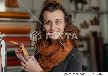 Stylish woman with curly hair in craft textile store, design concept Stylish woman with curly hair in craft textile store, design concept 114654668