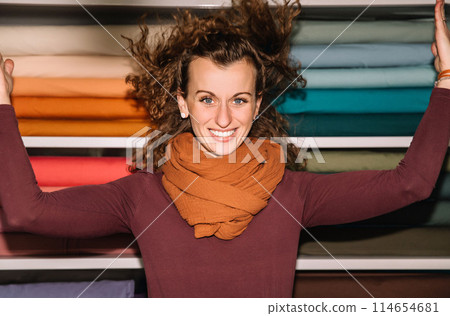 Stylish woman with curly hair in craft textile store, design concept 114654681