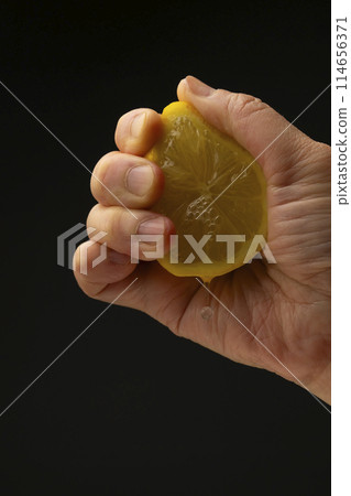 Squeezing lemon Black background Squeezing lemon Black background 114656371