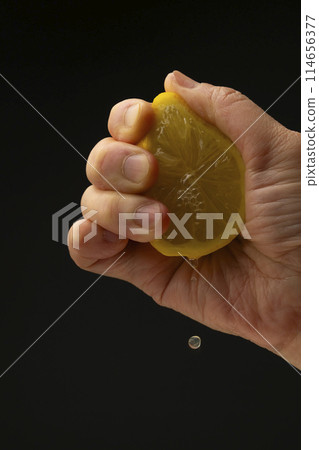 Squeezing lemon Black background Squeezing lemon Black background 114656377