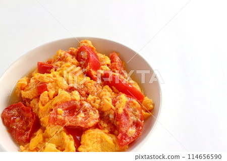 Fried eggs with tomatoes on white background 114656590
