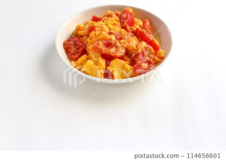 Fried eggs with tomatoes on white background Fried eggs with tomatoes on white background 114656601