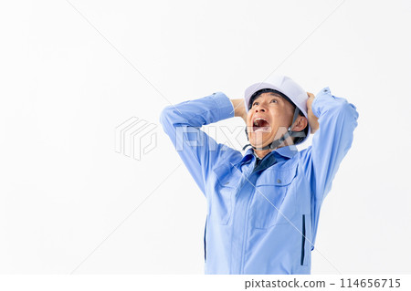 Man in work clothes, helmet, surprised 114656715