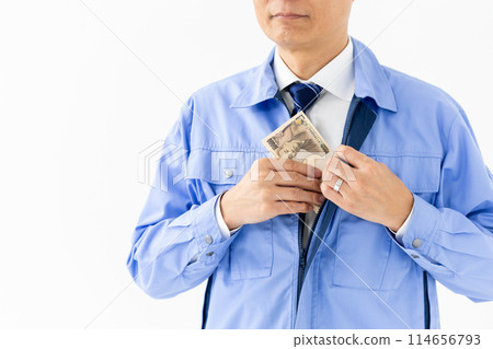 Man in work clothes, stack of bills, no face 114656793