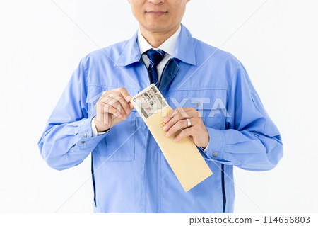 Man in work clothes, stack of bills, envelope, no face 114656803