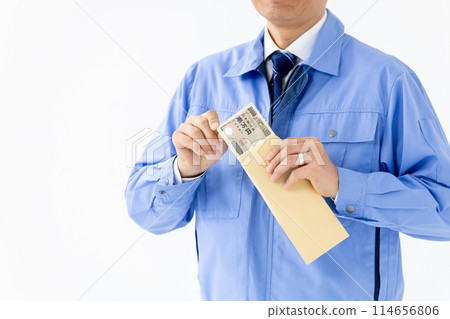 Man in work clothes, stack of bills, envelope, no face 114656806
