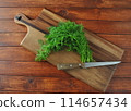 Fresh dill on wooden board. Rustic background 114657434