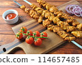 Barbecue meat. Chicken kebab. Chicken Shashlik with vegetables on wooden background. Rustic style. Top view 114657485