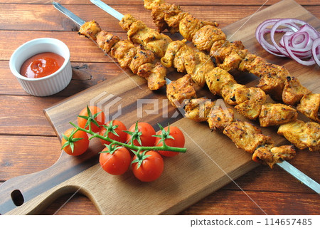 Barbecue meat. Chicken kebab. Chicken Shashlik with vegetables on wooden background. Rustic style. Top view 114657485