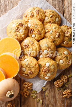 Pumpkin Walnut Chocolate Chip Cookies closeup on the parchment. Vertical 114658446