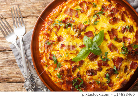 Tasty Crustless Quiche with bacon, egg, chicken and cheese closeup on the plate. Horizontal top view 114658460