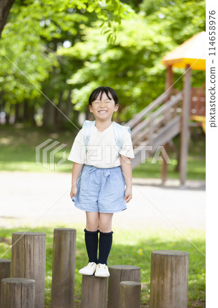Girls carrying a school bag 114658976