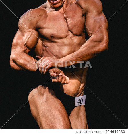 bodybuilder athlete show side chest pose for bodybuilding competition 114659380