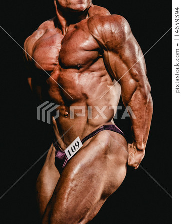 bodybuilder athlete show side triceps for bodybuilding competition bodybuilder athlete show side triceps for bodybuilding competition 114659394