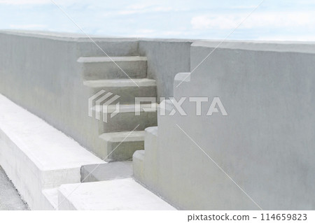 minimalistic concrete steps and wall under cloudy sky 114659823