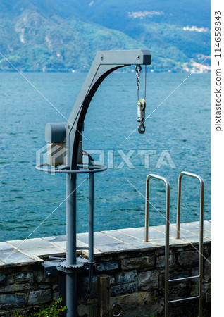 dockside crane with lake and mountains 114659843