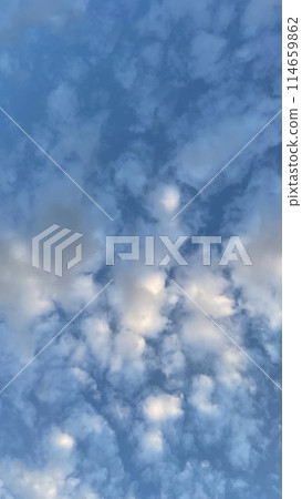 A Dramatic Sky at Dawn.The Mesmerizing Dance of Early Morning Clouds.Early Morning Drama.The Enchanting Dance of Dawn Clouds. 114659862