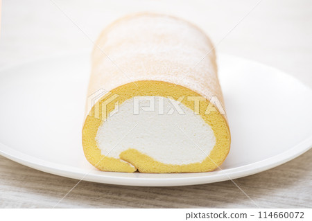 Roll cake on a white plate, cream roll cake, delicious sweets 114660072