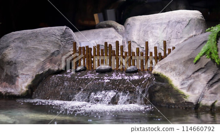 Close up of indoor mini pond waterfall Japanese style. 114660792