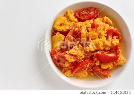 Fried eggs with tomatoes on white background Fried eggs with tomatoes on white background 114661923