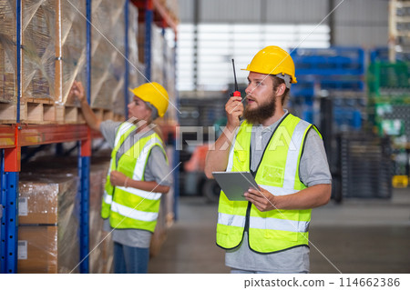 Male professional walkie talkie control worker in warehouse. Male professional walkie talkie control worker in warehouse. 114662386
