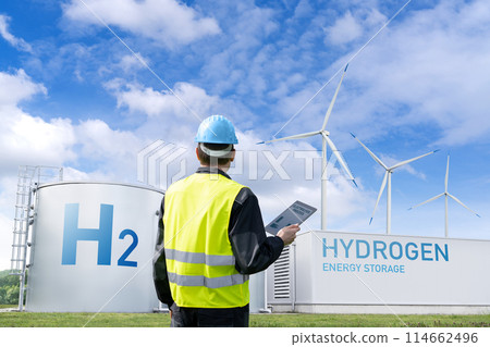 Engineer with tablet computer on a background of Hydrogen factory.. Engineer with tablet computer on a background of Hydrogen factory.. 114662496