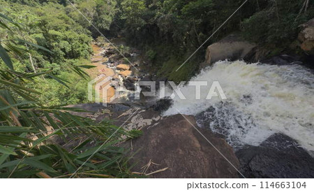Slow Motion Waterfall in Lush Jungle with People Bathing 114663104