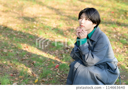 A woman enjoying the autumn leaves 114663640