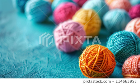 Close up colorful balls of yarn on blue background with copy space, banner with collection of colors woolen skeins for knitting thread 114663955