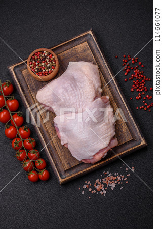 Raw chicken thighs with salt, spices and herbs Raw chicken thighs with salt, spices and herbs 114664077