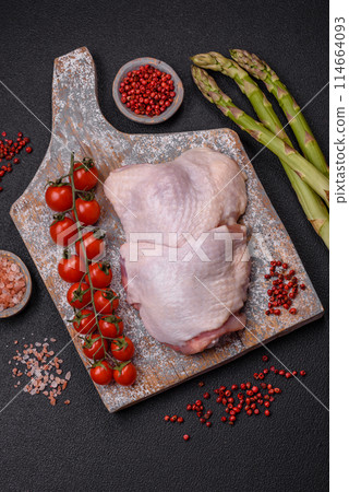 Raw chicken thighs with salt, spices and herbs 114664093