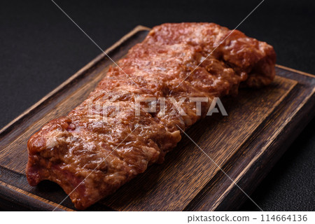 Raw pork ribs marinated with salt, spices and herbs 114664136