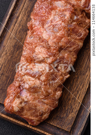 Raw pork ribs marinated with salt, spices and herbs Raw pork ribs marinated with salt, spices and herbs 114664138