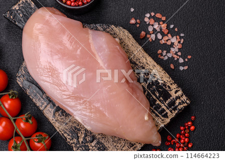 Raw chicken fillet with salt, spices and herbs 114664223