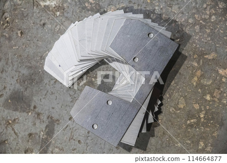 Laser cut iron parts in factory warehouse Laser cut iron parts in factory warehouse 114664877
