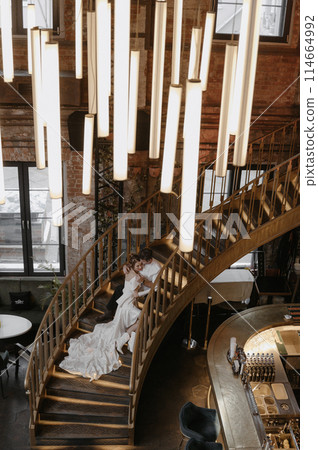 A young couple in wedding looks posing in a stylish loft bar. 114664992